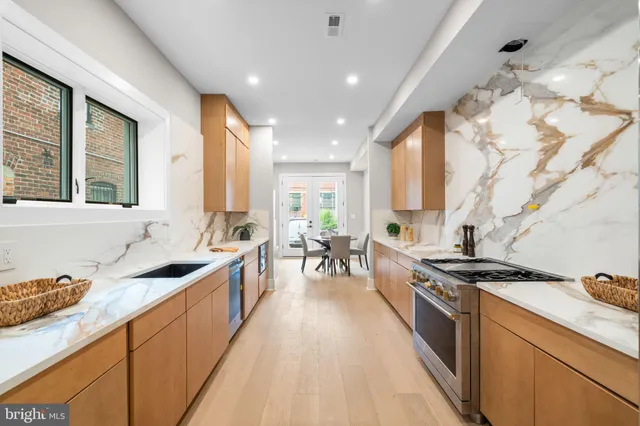 a kitchen with stainless steel appliances a stove sink and cabinets