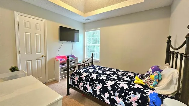 a bedroom with a bed and a chandelier