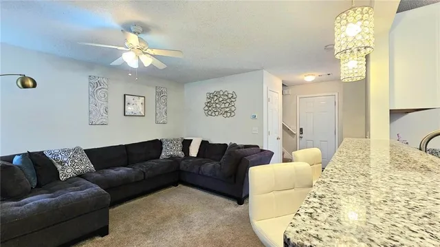 a living room with furniture and a chandelier
