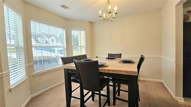 a view of a dining room with furniture window and outside view