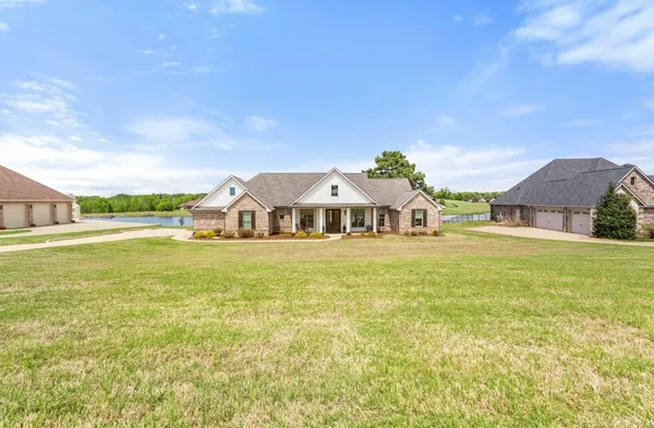 a front view of a house with a big yard