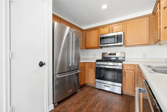 a kitchen with stainless steel appliances granite countertop a refrigerator microwave and sink
