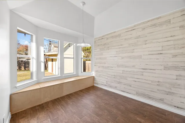 a view of wooden floor and windows in a room