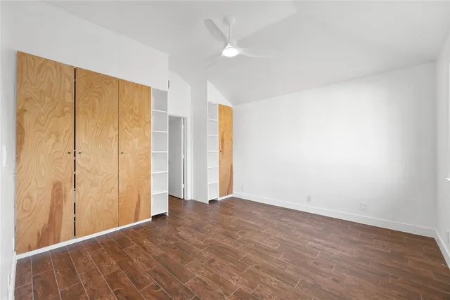 a large white kitchen with a sink and a refrigerator