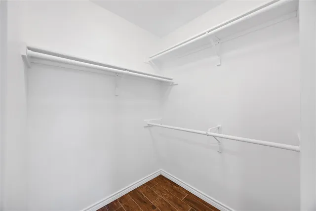 a bathroom with a tub sink double vanity granite and shower