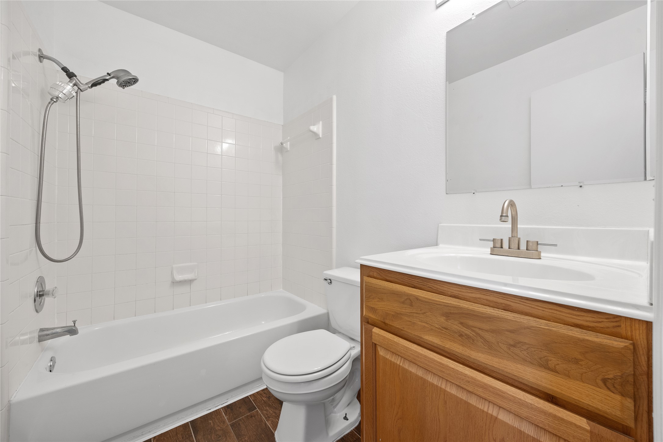 811 Lantana Lane Leander, TX 78641 - Photo 18 of 25 Full bath with vanity, wood tiled floors, and washtub / shower combination