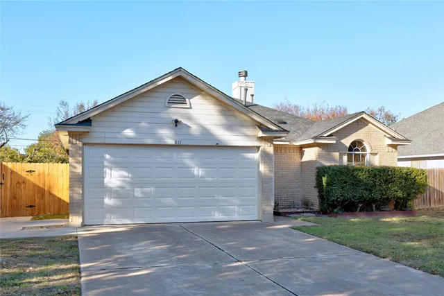 a view of a white house with a yard