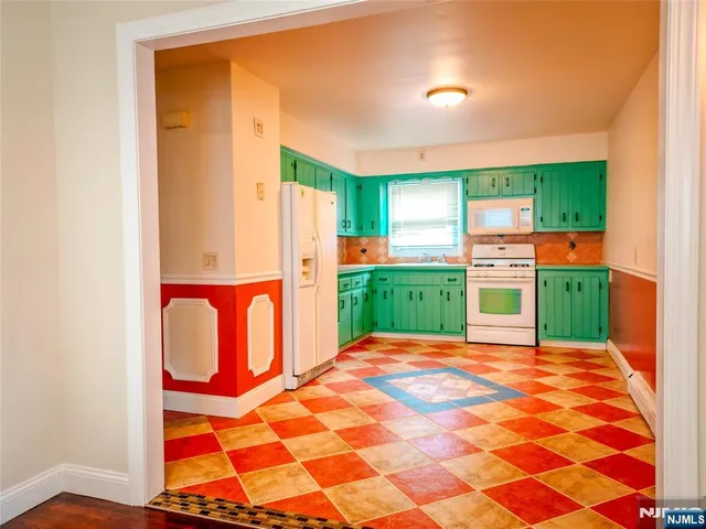 a view of a room with window and kitchen view