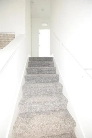 a view of staircase with white walls