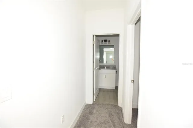 a view of a bathroom from a hallway