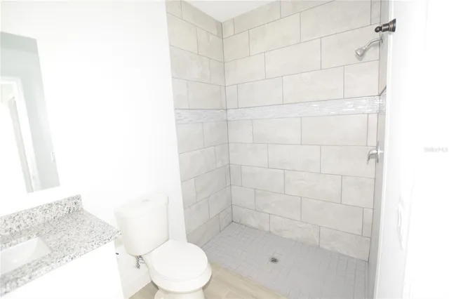 a bathroom with a shower and a toilet