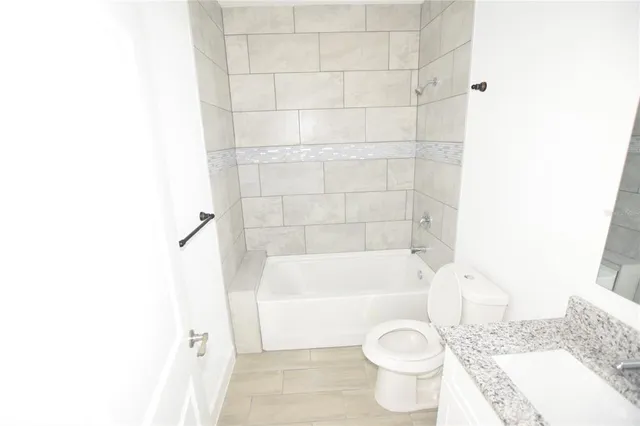 a bathroom with a toilet and a bath tub
