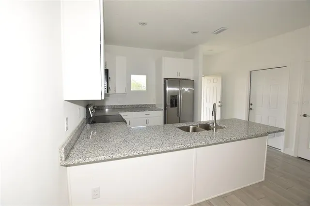 a kitchen with granite countertop a sink and a granite counter tops