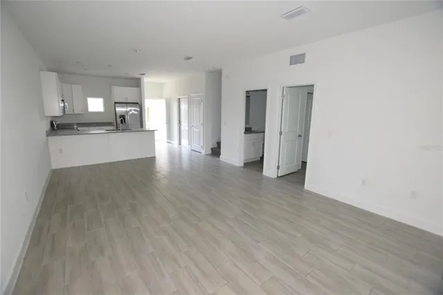 a view of a kitchen with a sink and a refrigerator