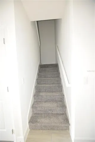 a view of staircase with white walls