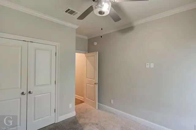 an empty room with a ceiling fan
