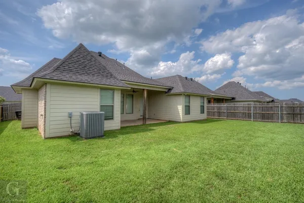 a front view of house with yard and garage