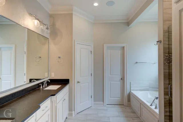 a bathroom with a tub sink and mirror