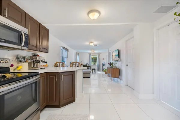 a kitchen with stainless steel appliances granite countertop a stove top oven a sink dishwasher and cabinets