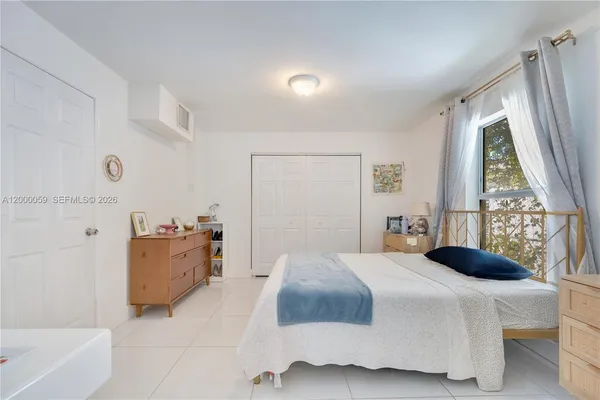 a bedroom with a bed and a dresser