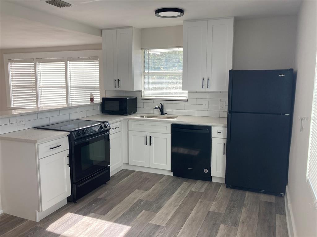 5200 3rd Avenue South St. Petersburg, FL 33707 - Photo 11 of 47 a kitchen with a sink stove and refrigerator