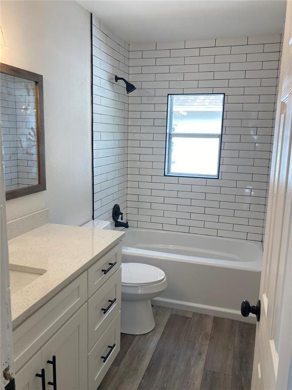 5200 3rd Avenue South St. Petersburg, FL 33707 - Photo 13 of 47 a bathroom with a granite countertop toilet a sink and bathtub