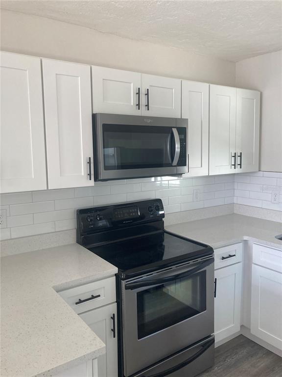 5200 3rd Avenue South St. Petersburg, FL 33707 - Photo 23 of 47 a kitchen with microwave stove and cabinets