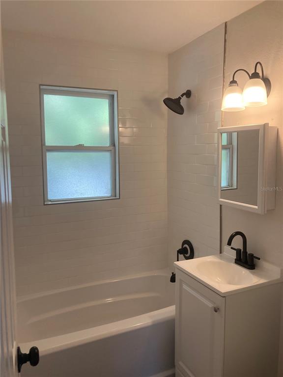 5200 3rd Avenue South St. Petersburg, FL 33707 - Photo 26 of 47 a bathroom with a tub a sink and a window
