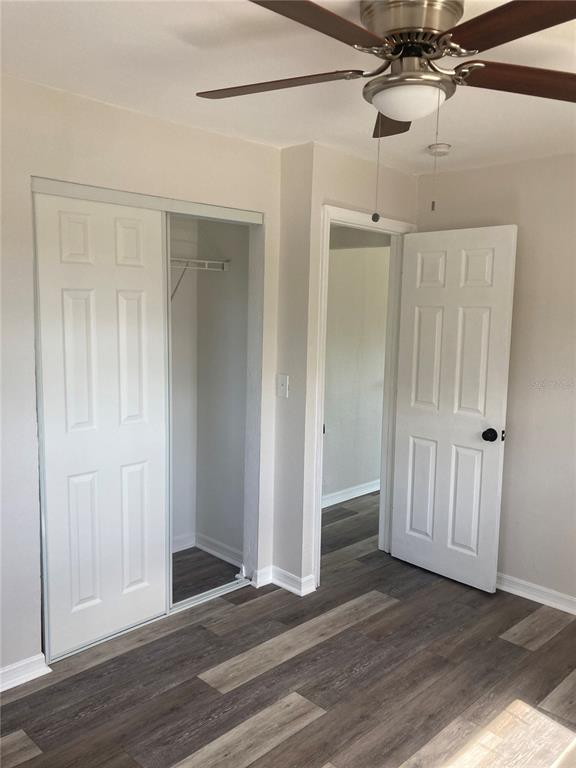 5200 3rd Avenue South St. Petersburg, FL 33707 - Photo 32 of 47 an empty room with wooden floor a ceiling fan and entryway