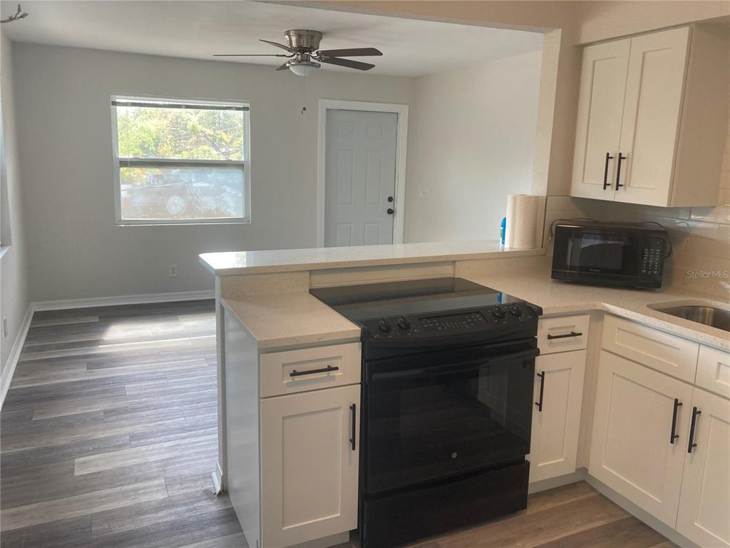5200 3rd Avenue South St. Petersburg, FL 33707 - Photo 38 of 47 a kitchen with a stove and a microwave