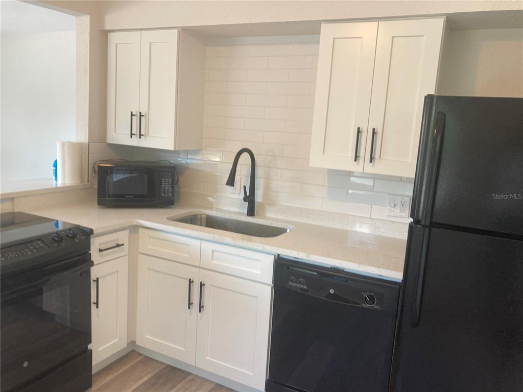 5200 3rd Avenue South St. Petersburg, FL 33707 - Photo 39 of 47 a kitchen with a refrigerator sink and cabinets