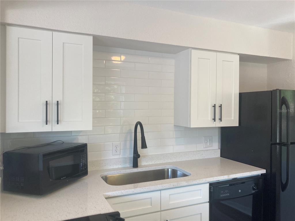 5200 3rd Avenue South St. Petersburg, FL 33707 - Photo 40 of 47 a kitchen with a sink and a refrigerator