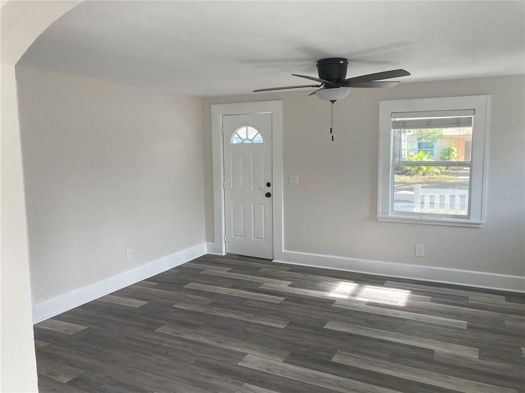5200 3rd Avenue South St. Petersburg, FL 33707 - Photo 5 of 47 a view of empty room with wooden floor and ceiling fan