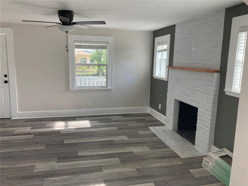 5200 3rd Avenue South St. Petersburg, FL 33707 - Photo 6 of 47 a view of an empty room with a fireplace and a window