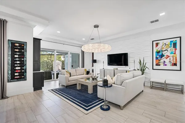 a kitchen with stainless steel appliances kitchen island granite countertop a dining table chairs and white cabinets