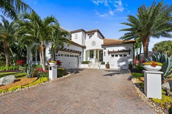 a view of a house with swimming pool and sitting area
