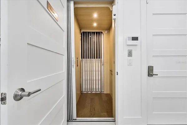 a bedroom with a bed a large window and a flat screen tv