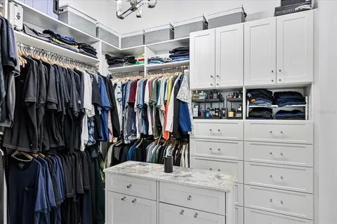 a bedroom with a bed and a large mirror