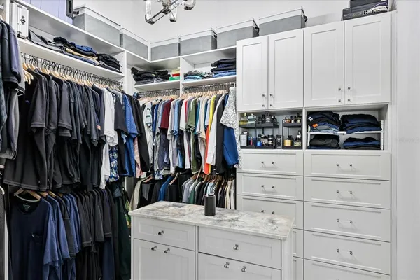 a bedroom with a bed and a large mirror