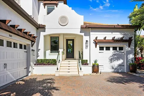 a living room with furniture a flat screen tv and a chandelier