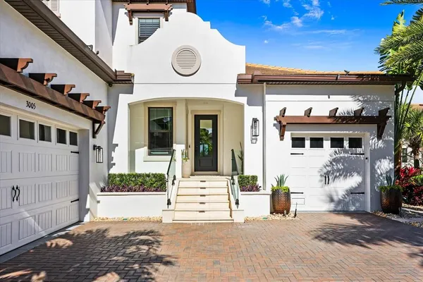 a living room with furniture a flat screen tv and a chandelier