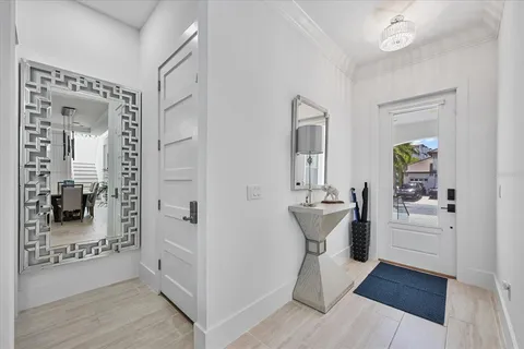 a living room with furniture a flat screen tv and a window