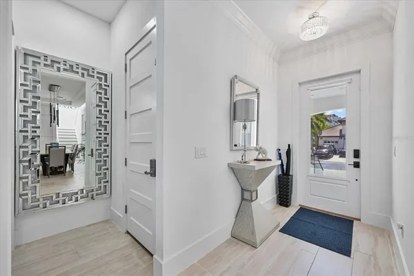 a living room with furniture a flat screen tv and a window