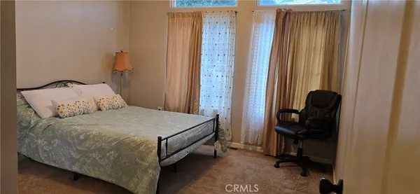 a bedroom with a bed and a mirror