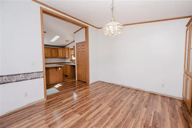 a kitchen with stainless steel appliances kitchen island granite countertop a stove a sink and a refrigerator