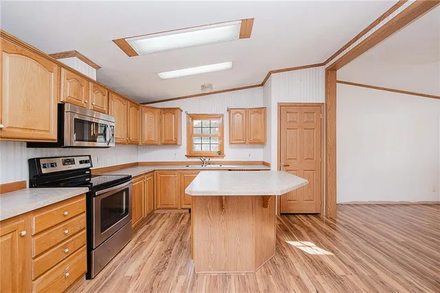 a kitchen with a stove a sink and a refrigerator