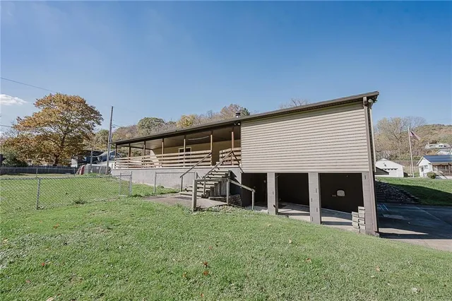 a big yard with trees in front of it