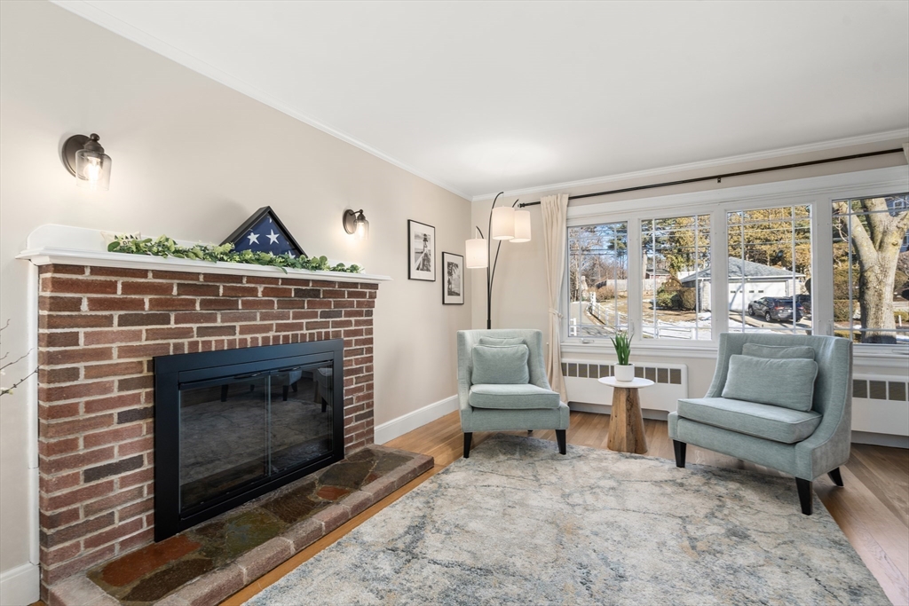 48 Spring Street Wakefield, MA 01880 - Photo 4 of 28 a living room with furniture and a fireplace