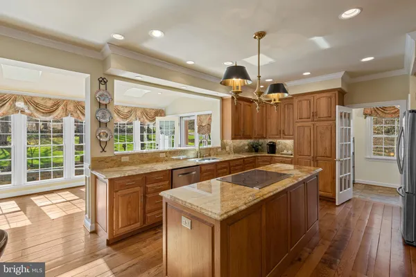 a kitchen with stainless steel appliances granite countertop sink stove and refrigerator