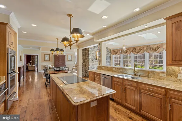 a view of a kitchen with refrigerator and wooden floor